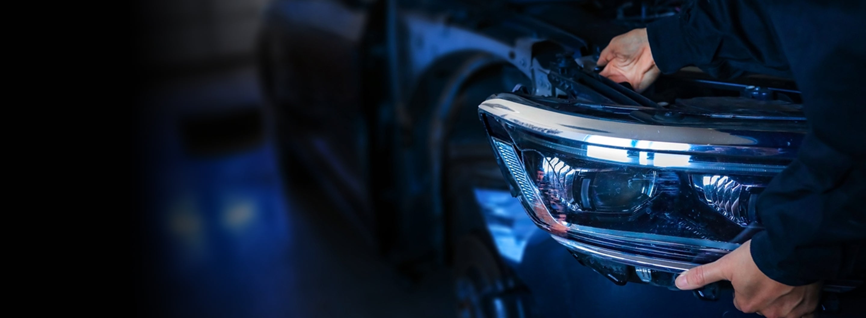 Mechanic installing a premium car headlight – PartsPrime
